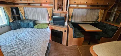 a small room with a bed and a tv in it at Каравана Сий-я-на in Sozopol
