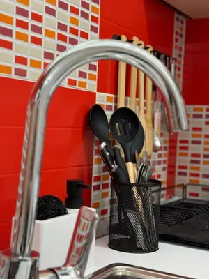 a kitchen sink with a kitchen utensils in a holder at Dayanas Suite in Varna City