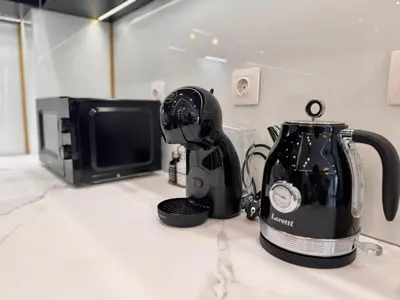 a blender sitting on a counter next to a microwave at Luxury Apartment with Parking Just Steps from the Beach in the Heart of Burgas! in Burgas City