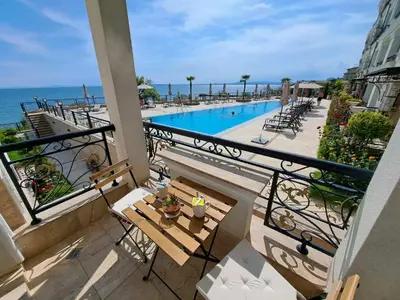 a balcony with a view of a swimming pool at Onyx Private Apartments in Sveti Vlas