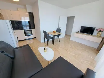 a living room with a couch and a table at Onyx Private Apartments in Sveti Vlas