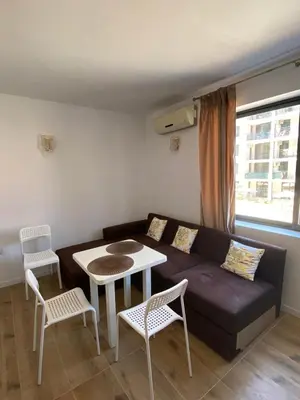 a living room with a couch and a table and chairs at Avalon Lux in Sunny Beach