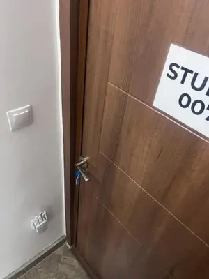 a wooden door with a sign on it at Studio 007 с градинка in Burgas City