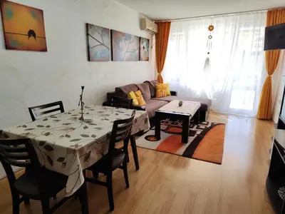 a living room with a table and a couch at Nev 1 in Burgas City