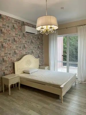 a bedroom with a large bed and a chandelier at Luxury Villa in Sozopol in Sozopol