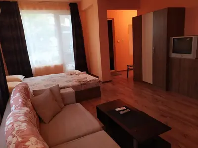 a living room with a couch and a tv at HOUSEDENz in Chernomorets