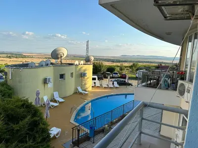a view of a swimming pool on top of a building at Apartament Sunset Kosharitsa - Slunchev briag in Kosharitsa