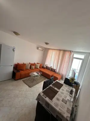 a living room with a couch and a table at Apartament Sunset Kosharitsa - Slunchev briag in Kosharitsa