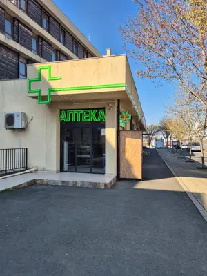 an entrance to an apartment building with a pharmacy at Luxor Zaks Apartments in Sveti Vlas