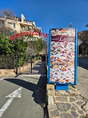 a sign on the side of a street at Luxor Zaks Apartments in Sveti Vlas