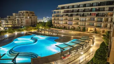 a large swimming pool in front of a building at Luxor Zaks Apartments in Sveti Vlas