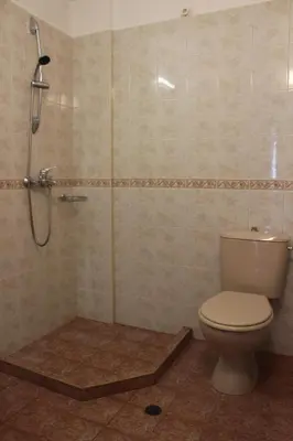 a bathroom with a toilet and a shower at Апартаменти Амфора in Pomorie