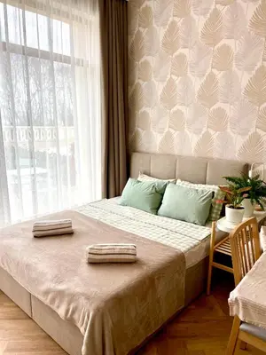 a bedroom with a large bed with two towels on it at Coral Bay Studio Varna - Beachfront with Free Parking in Varna City