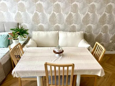 a white table with chairs and a couch in a room at Coral Bay Studio Varna - Beachfront with Free Parking in Varna City