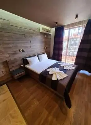 a bedroom with a bed with two towels on it at MitProt Panorama Bay 2 Luks Studio 29 in Sveti Vlas