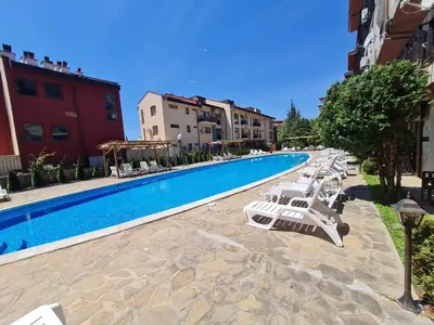 a swimming pool with lounge chairs next to a building at MitProt Panorama Bay 2 Luks Studio 29 in Sveti Vlas