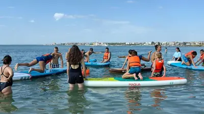 a group of people on surfboards in the water at Apartment Rosa Marina in Nesebar