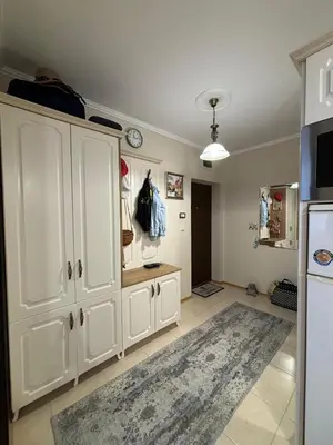 a kitchen with white cabinets and a rug at Apartment Rosa Marina in Nesebar