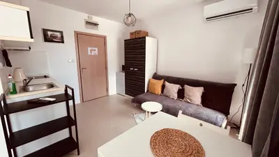 a small living room with a couch and a sink at Rainbow 3-213 Large Studio Delux in Sunny Beach