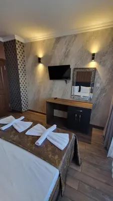 a room with a bed with napkins and a mirror at MitProt Panorama bay 2 Luks Apartment 175 in Sveti Vlas