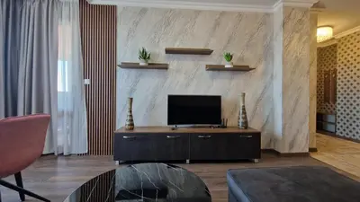 a living room with a flat screen tv on a wall at MitProt Panorama bay 2 Luks Apartment 175 in Sveti Vlas