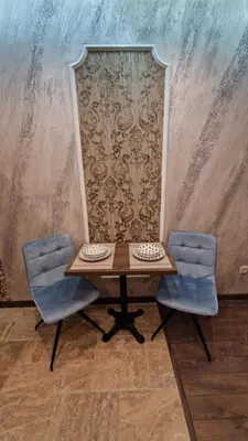 a table and two chairs in front of a wall at MitProt Panorama Bay 2 luks Studio 143 in Sveti Vlas
