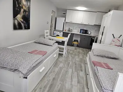 a small room with two beds and a kitchen at Студио за гости на град Бургас in Burgas City