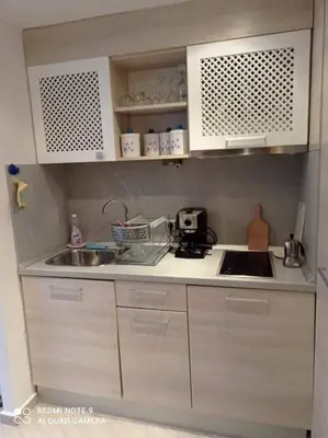 a kitchen with white cabinets and a sink at Studio Quatro - South Pearl - Sozopol in Sozopol