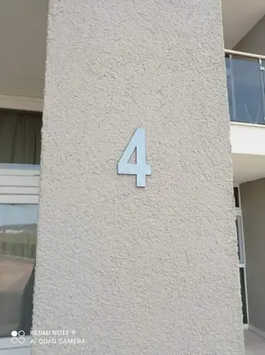 a number four on the side of a building at Studio Quatro - South Pearl - Sozopol in Sozopol