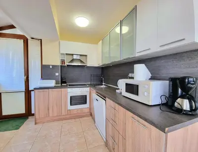 a kitchen with a counter top with a microwave at Sunny View Apartment with Garage in Burgas City