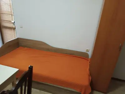 a bed with an orange mattress in a room at Stamopolu apartament 1 in Primorsko