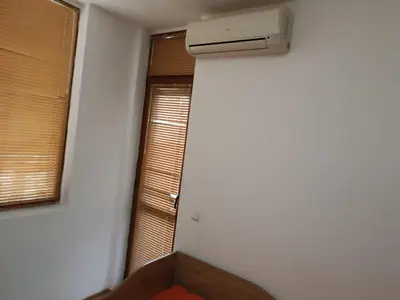 an empty room with a heater and a window at Stamopolu apartament 1 in Primorsko