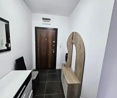 a room with a wooden bench in front of a door at Rose Garden Deluxe in Chernomorets