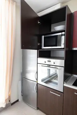 a kitchen with a stove and a microwave at Reina Apart Kamelia Garden in Sunny Beach