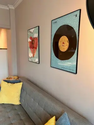 a living room with a couch and two pictures on the wall at Sea Breeze l 2BD Sea Garden Apartment in Varna City