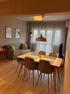 a living room with a table and chairs and a couch at Sea Breeze l 2BD Sea Garden Apartment in Varna City