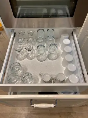 a drawer filled with glasses and plates in a refrigerator at Sea Breeze l 2BD Sea Garden Apartment in Varna City
