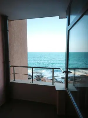 a room with a view of the ocean from a balcony at Sozopol Sunrise in Sozopol