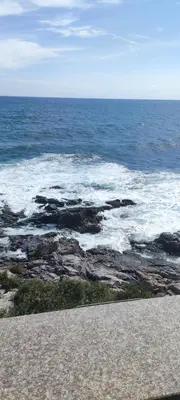 a view of the ocean with rocks and water at Sozopol Sunrise in Sozopol