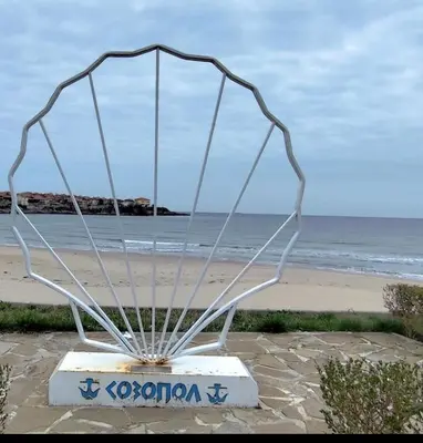 a metal sculpture of a net on the beach at Sozopol Sunrise in Sozopol