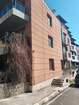 a building with a bush on the side of it at Studio in Sea Breeze Complex Sveti Vlas in Sveti Vlas