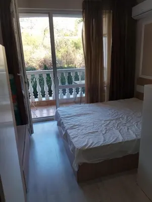 a bedroom with a bed and a balcony at Studio Apartment Villa Sardinia Sveti Vlas in Sveti Vlas