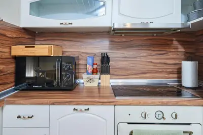 a kitchen counter with a microwave and a stove at Florance Rentals Luxury Apartments in Nessebar in Nesebar