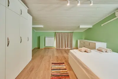a bedroom with two beds in a room with green walls at Florance Rentals Luxury Apartments in Nessebar in Nesebar