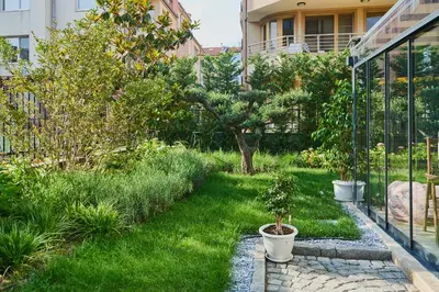 a garden with a potted tree in a yard at Florance Rentals Luxury Apartments in Nessebar in Nesebar