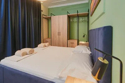 a bedroom with a large bed with towels on it at Florance Rentals Luxury Apartments in Nessebar in Nesebar