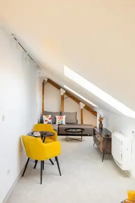 a living room with a couch and a yellow chair at Apartment Musala N 05 in Varna City