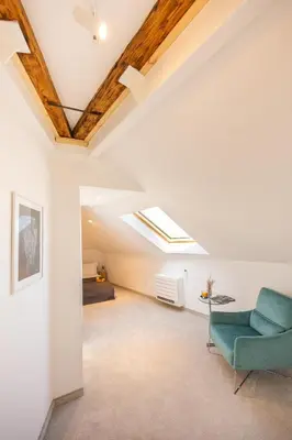 a loft conversion with a skylight and a couch and a bed at Apartment Musala N 06 in Varna City