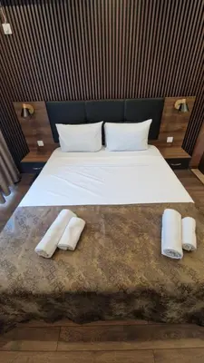 a bedroom with a bed with two towels on it at MitProt Panorama Bay 2 Luks Studio 32 in Sveti Vlas