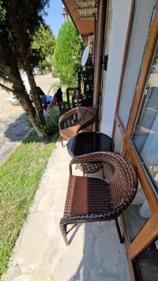 three wicker benches sitting outside of a building at MitProt Panorama Bay 2 Luks Studio 32 in Sveti Vlas
